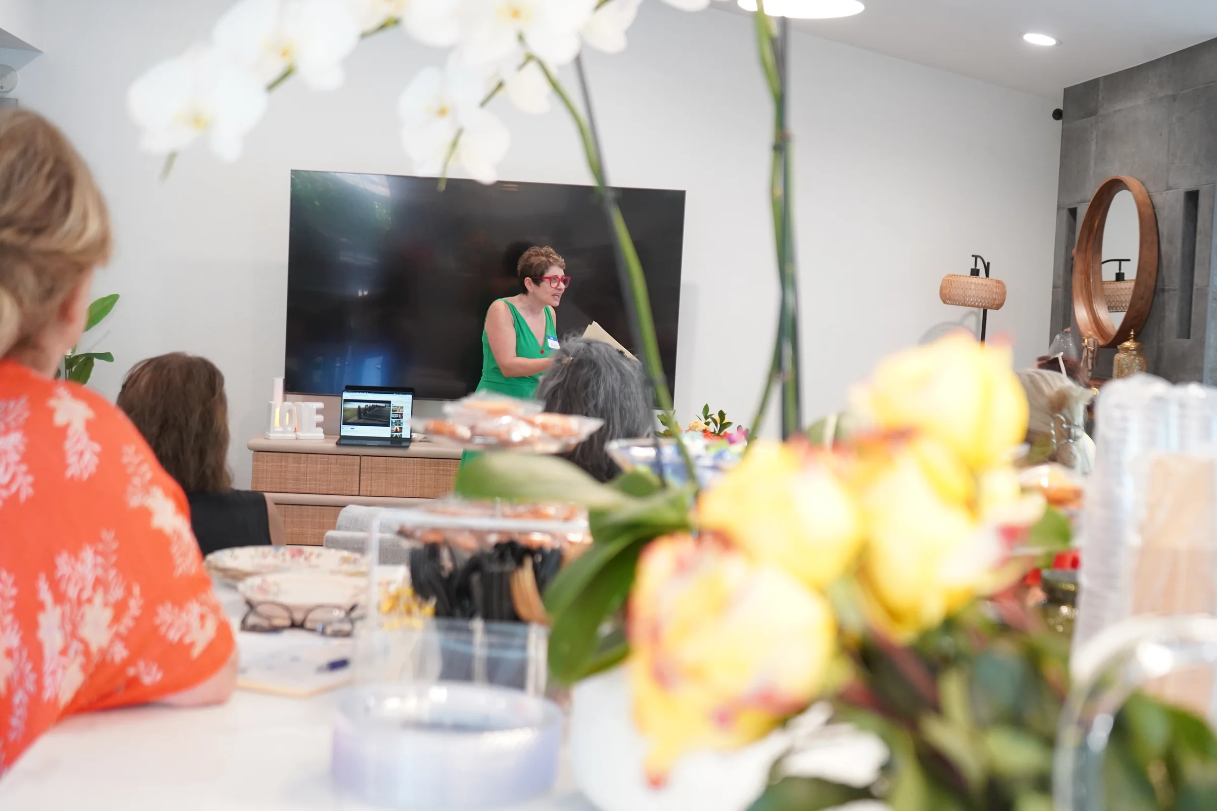 Flowers and breakfast in the foreground with the host and group beyond