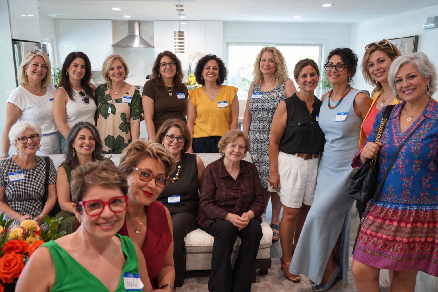 Women from the first Women in Transition gathering smiling together for a group photo